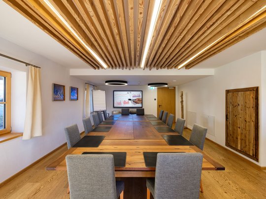 Conference rooms of our seminar hotel in Upper Bavaria Modern meeting room with large wooden table and gray chairs